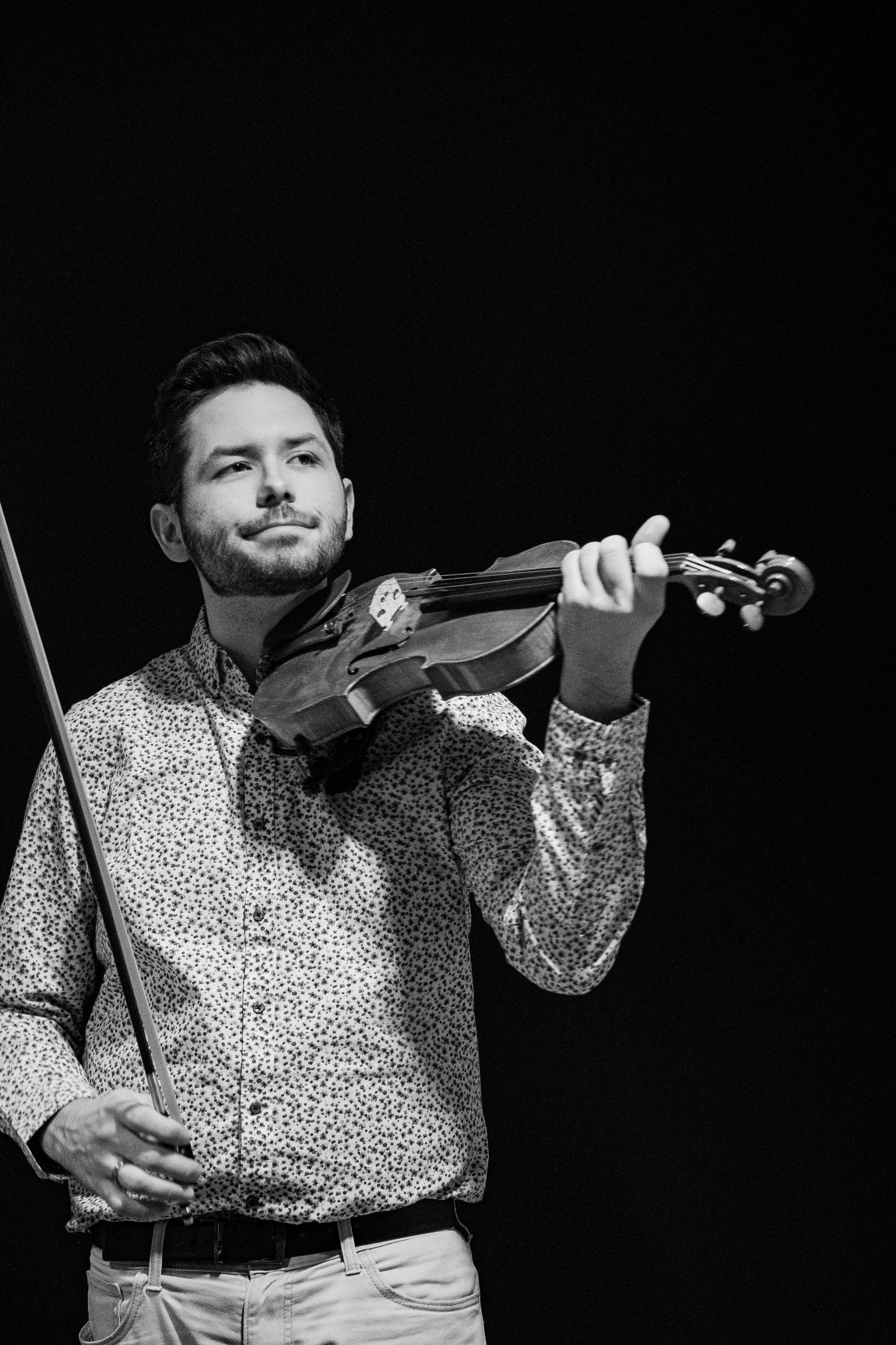 Mike bringing his violin up to play